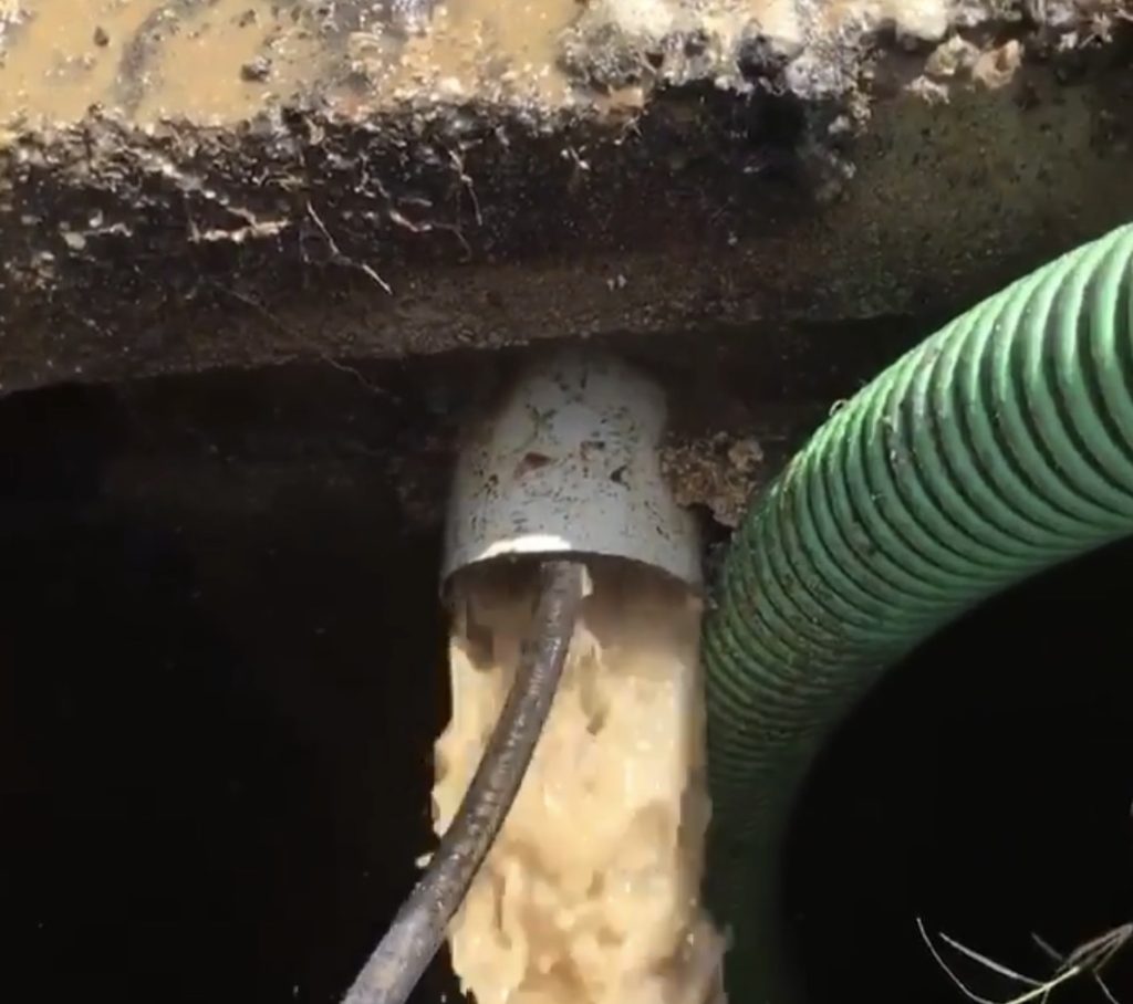 High-pressure hydro jetting equipment cleaning grease and buildup inside sewer pipe
