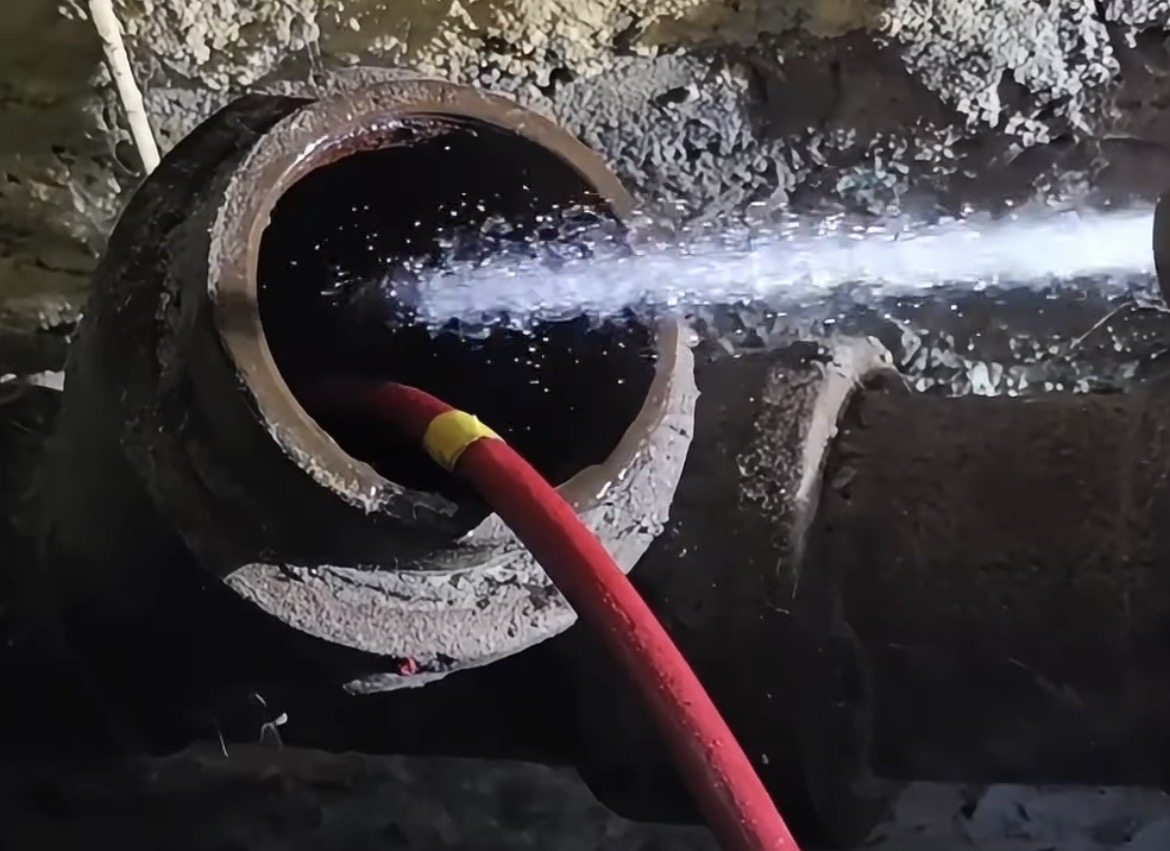 Hydro jetting drain cleaning service clearing underground sewer and drainage line blockage