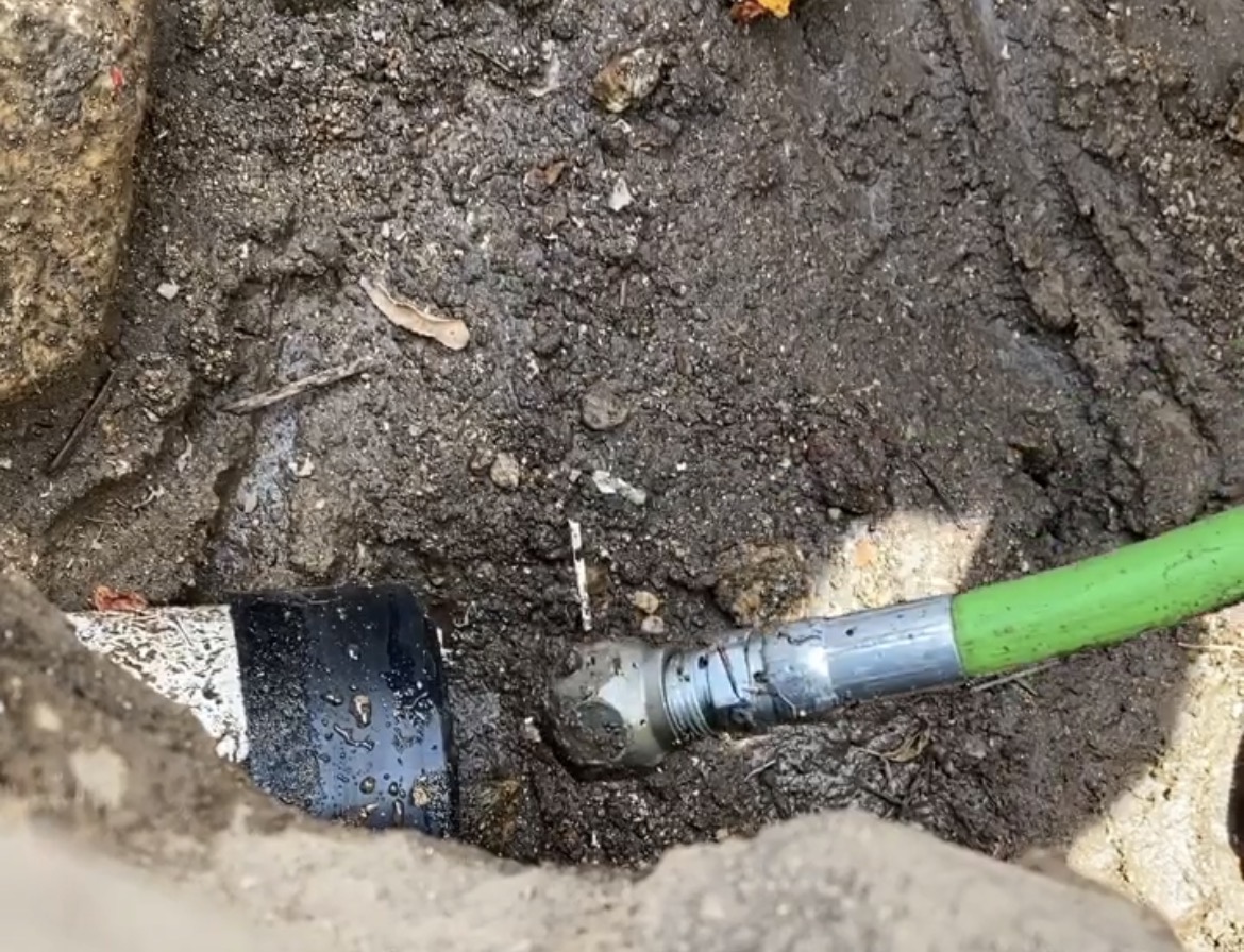High-pressure hydro jetting equipment cleaning grease and buildup inside sewer pipe