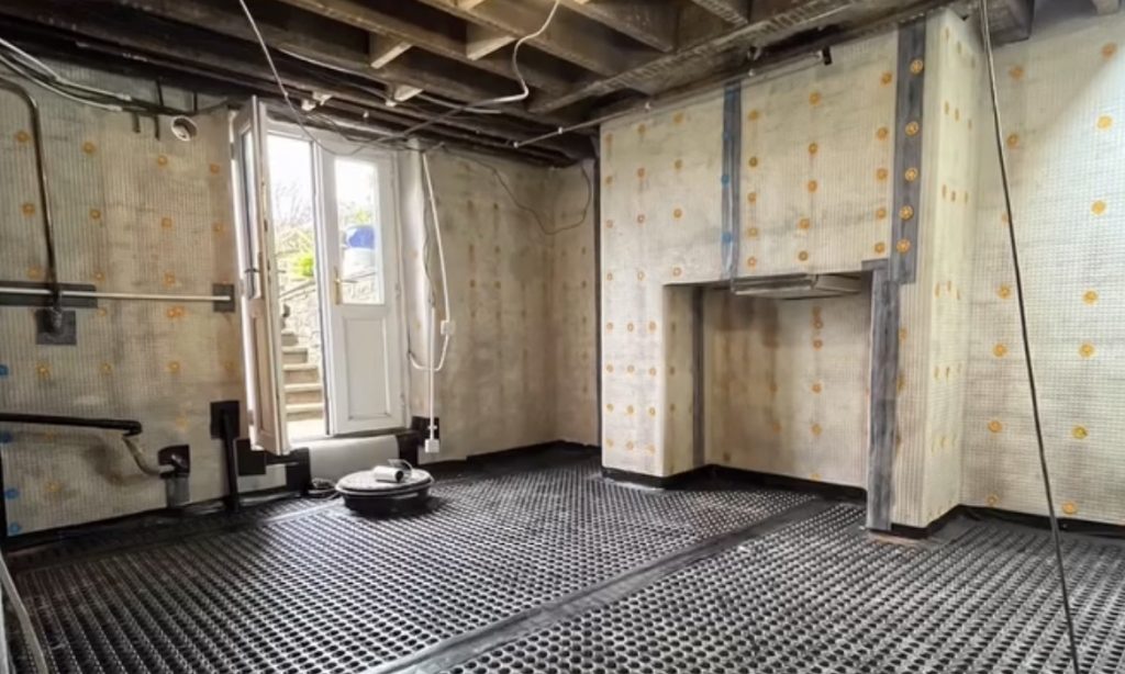 Interior basement waterproofing drainage system with moisture protection membrane